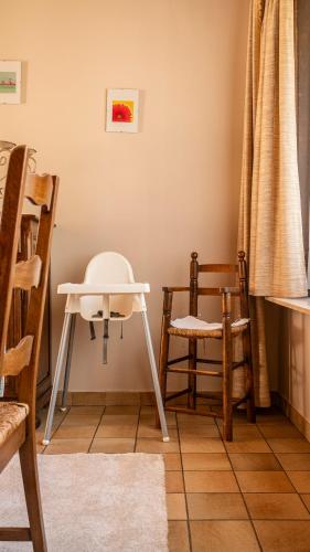 a room with chairs and a white table and a chair at Villa Maurice close to the beach in Oostduinkerke