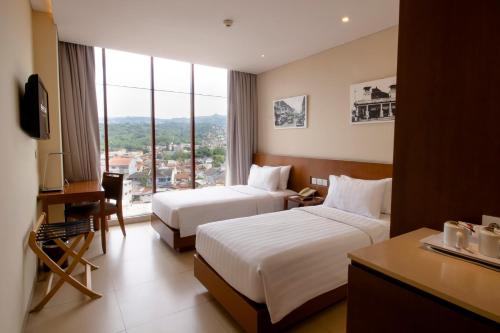 Ένα ή περισσότερα κρεβάτια σε δωμάτιο στο PRIME PARK Hotel Bandung