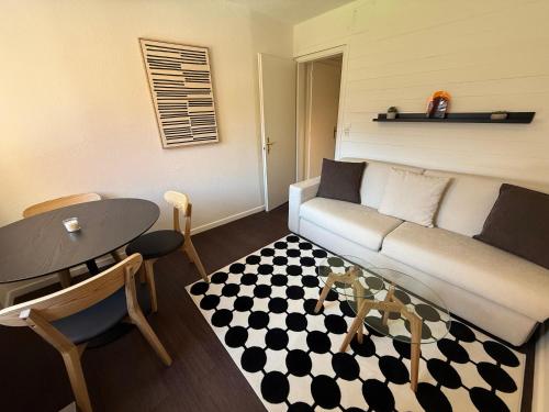 a living room with a couch and a table at Jäggi 35 by Arosa Holiday in Arosa
