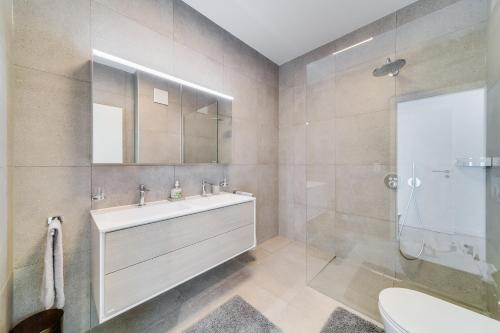 a bathroom with a sink and a shower at Modern 5-Star Stay in Glion - Underfloor Heating in Montreux