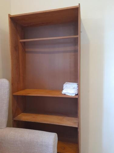 a closet with wooden shelves in a room at Swahili lodge nungwi in Kinyasini