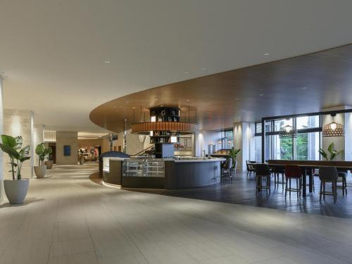 a lobby with a kitchen and a dining area at Novotel Okinawa Naha in Naha
