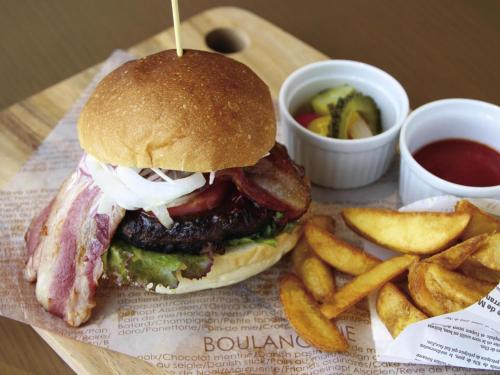 a hamburger and french fries on a tray with ketchup at Novotel Okinawa Naha in Naha