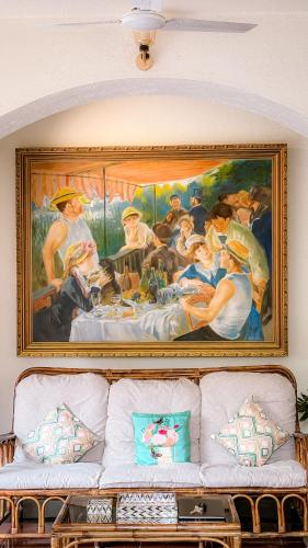 a painting on the wall above a couch at Aeraki palms in Bordi