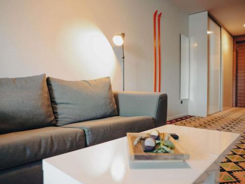 a living room with a couch and a table at ibis Styles Sarajevo in Sarajevo