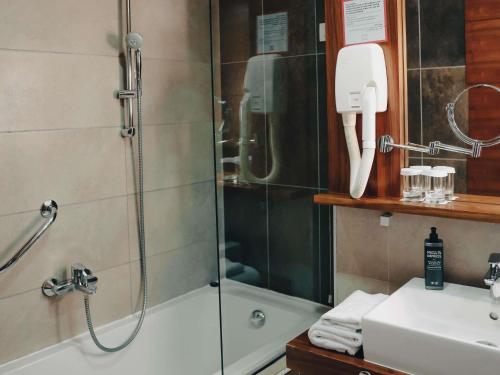 a bathroom with a shower and a sink at ibis Styles Sarajevo in Sarajevo