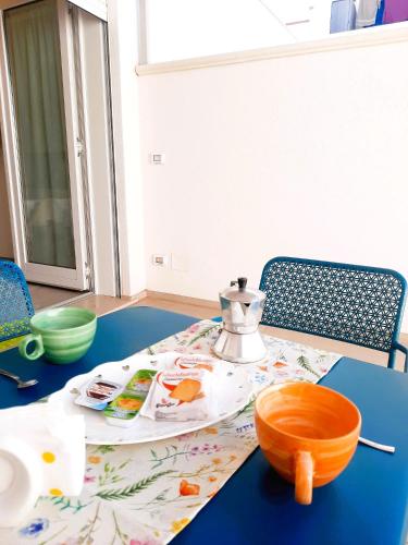a table with a tea pot on top of it at Azzurro Mare Aparthotel in Torre Mozza