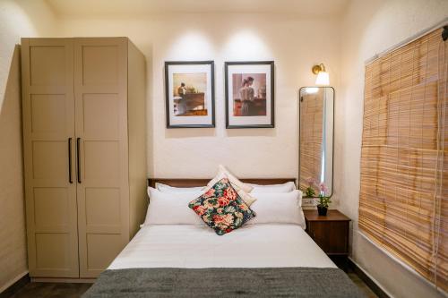 a bedroom with a bed and two pictures on the wall at Aeraki palms in Bordi