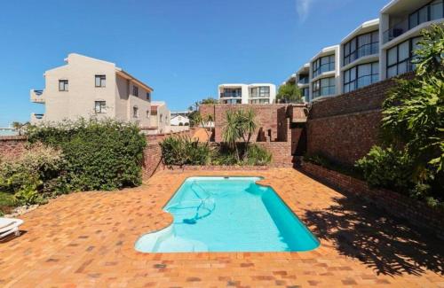 an empty swimming pool in the middle of a brick yard at Seascape Plettenberg Bay in Plettenberg Bay