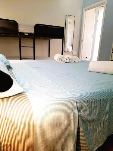 a bedroom with a large bed with a mirror at Azzurro Mare Aparthotel in Torre Mozza