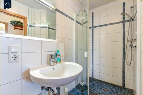 a bathroom with a sink and a shower at Ferienwohnung Strandblick 2 in Ueckeritz