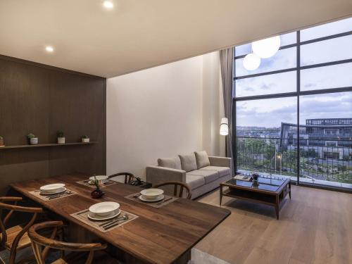 a living room with a table and a couch at Novotel Suites Shanghai Hongqiao in Shanghai