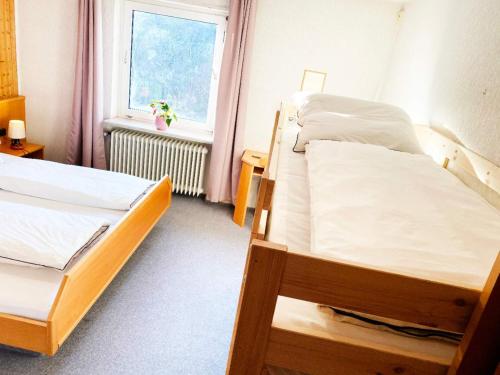 a bedroom with two bunk beds and a window at Zum Goldenen Löwen in Oberzent