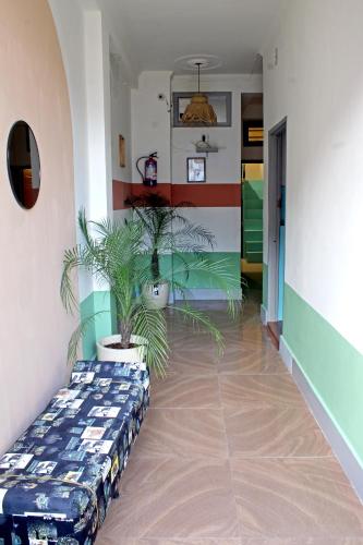a hallway with a couch and plants in a room at Hostel De Offlanders Rishikesh - Stay Connect & Explore in Tapovan