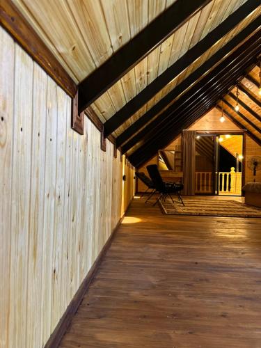 a large wooden building with a wooden deck at شاليه وكوخ البركه Albarakah chalets in Ajloun
