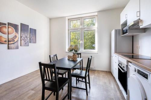 a kitchen and dining room with a table and chairs at Key2Komfort in Duisburg