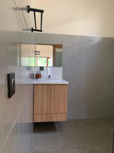 a bathroom with a sink and a mirror at Permata Villas Lombok in Kuta Lombok