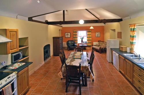 a kitchen with a table and chairs in a room at 2 Bed in Maam oc-i252 in Claggan
