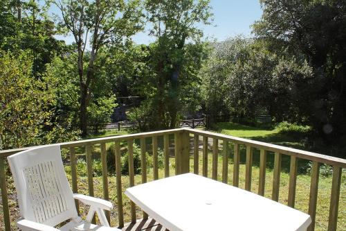 a white table and chairs on a wooden deck at 2 Bed in Maam oc-i252 in Claggan