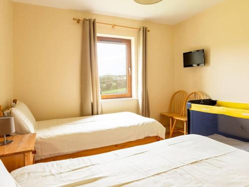 a room with two beds and a window at 3 Bed in Ardrinane oc-ii05005 in Annascaul