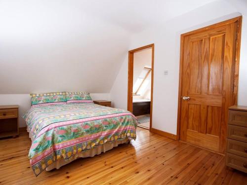 a bedroom with a bed and a wooden floor at 3 Bed in Achill Island oc-ii16114 in Slievemore