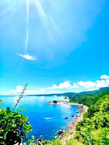 a view of a body of water with a beach at プライベート天然温泉 - 広々清潔 - 素敵な非日常! Private Hot Spring - Spotless Modern Japanese in Ito