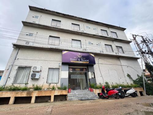 een gebouw met twee motorfietsen ervoor geparkeerd bij Era Hotel and Reosrt in Kota