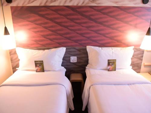 Cama o camas de una habitación en Hotel Ibis Tatui
