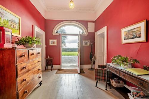 a red room with a dresser and a door at 3 Bed in Enniscorthy oc-ii16584 in Enniscorthy