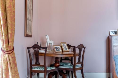 a table with two chairs and a table with ahibition at 3 Bed in Enniscorthy oc-ii16584 in Enniscorthy