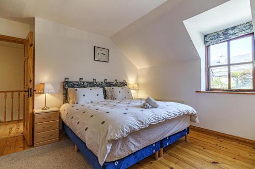 a bedroom with a large bed and a window at 3 Bed in Duncannon oc-i030 in Duncannon