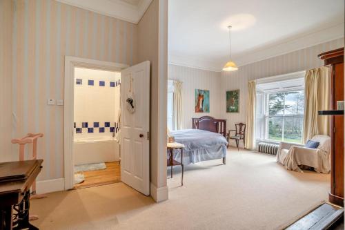 a bedroom with a bed and a bathroom with a tub at 3 Bed in Enniscorthy oc-ii16584 in Enniscorthy