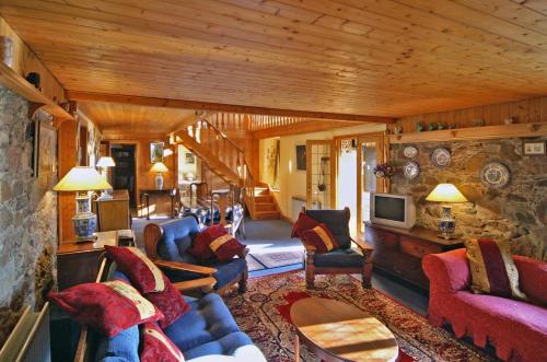 a living room with a couch and chairs and a tv at 4 Bed in Carne oc-i023 in Carne