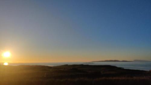 a sunset over the ocean with the sun setting at 3 Bed in Renvyle oc-i512 in Cashleen