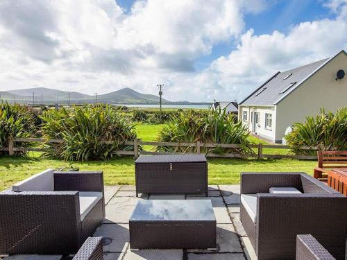 a patio with chairs and tables and a house at 4 Bed in Ballydavid oc-ii16672 in Murreagh