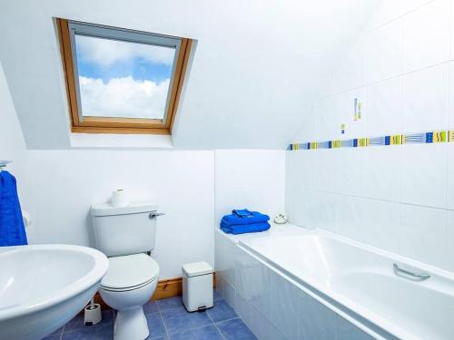 a white bathroom with a toilet and a sink at 4 Bed in Ballydavid oc-ii16672 in Murreagh