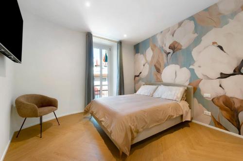 a bedroom with a bed and a flower mural on the wall at San Lorenzo Apartment in Giaveno