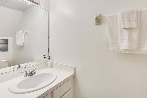 a white bathroom with a sink and a mirror at 23 Mi to NOLA Cozy and Quaint Destrehan Townhome in Destrehan