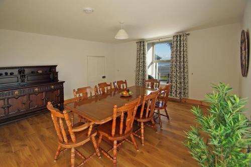 a dining room with a wooden table and chairs at 4 Bed in Kilbrittain oc-i445 in Courtmacsherry