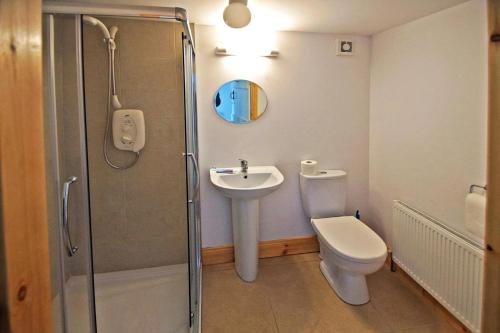 a bathroom with a shower and a toilet and a sink at 4 Bed in Kilbrittain oc-i445 in Courtmacsherry