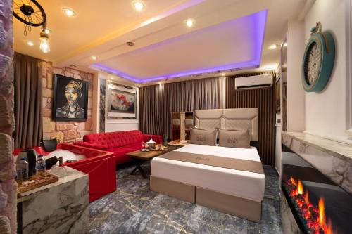 a hotel room with a bed and a fireplace at REN PLUS SUITES in Istanbul