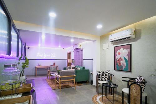 a living room with a green couch and chairs at Olive Hotel Indiranagar 100Ft Road by Embassy Group in Bengaluru