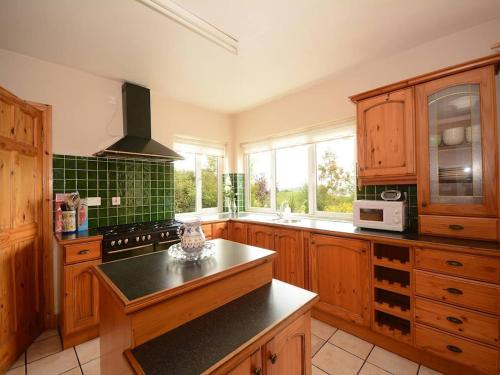 a kitchen with wooden cabinets and a black counter top at 5 Bed in Mountcharles oc-ii11344 in Mountcharles