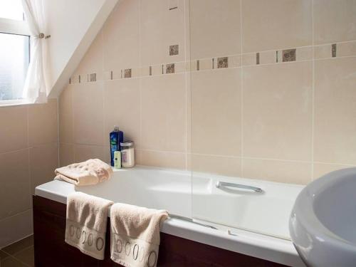 a bathroom with a bath tub and a sink at 4 Bed in Portnoo oc-ii16953 in Clogher