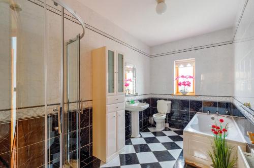 a bathroom with a tub and a toilet and a sink at 5 Bed in Westport oc-ii06251 in Aghagower