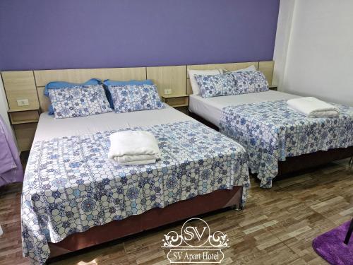 Ein Bett oder Betten in einem Zimmer der Unterkunft SV Apart Hotel
