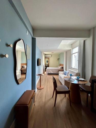 a living room with a couch and a table and a mirror at Iara & Muira Apartments in Belém