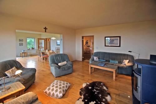 a living room with couches and a dog laying on the floor at 3 Bed in Inch oc-i444 in Caheracruttera