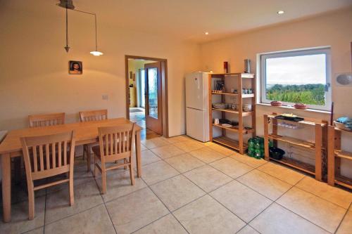 a kitchen and dining room with a table and a refrigerator at 3 Bed in Inch oc-i444 in Caheracruttera