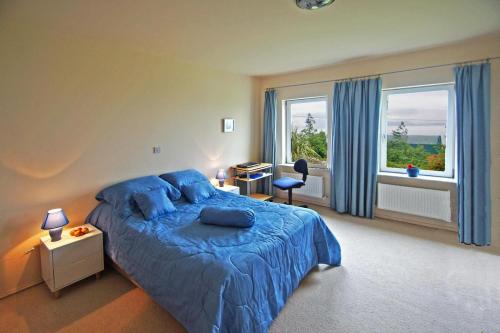 a bedroom with a blue bed and a window at 3 Bed in Inch oc-i444 in Caheracruttera